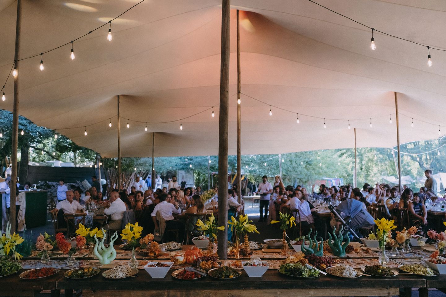 Wedding banquet beneath a Bedu tent decorated with garlands