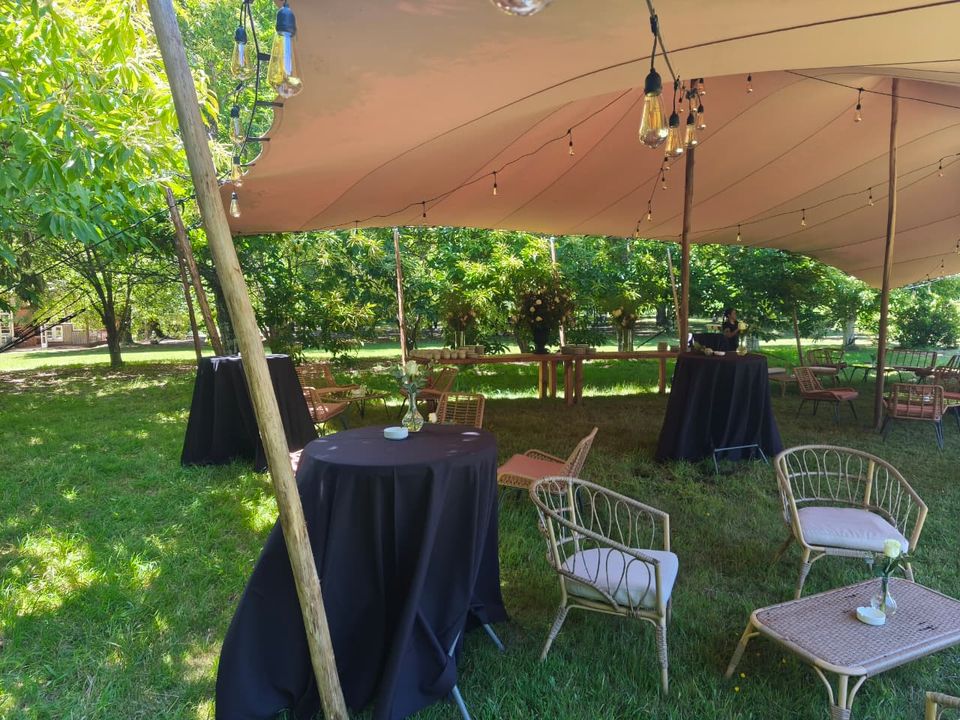 Event dinner with warm lighting beneath a stretch tent