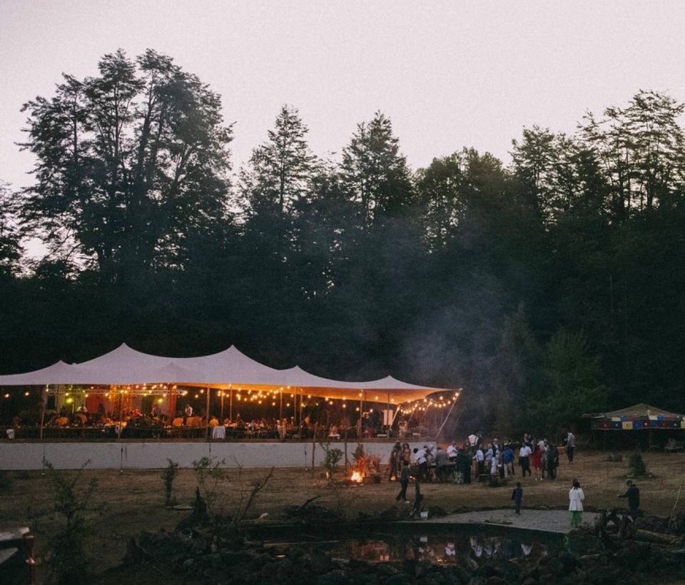 Night event with guests beneath an illuminated Bedouin tent