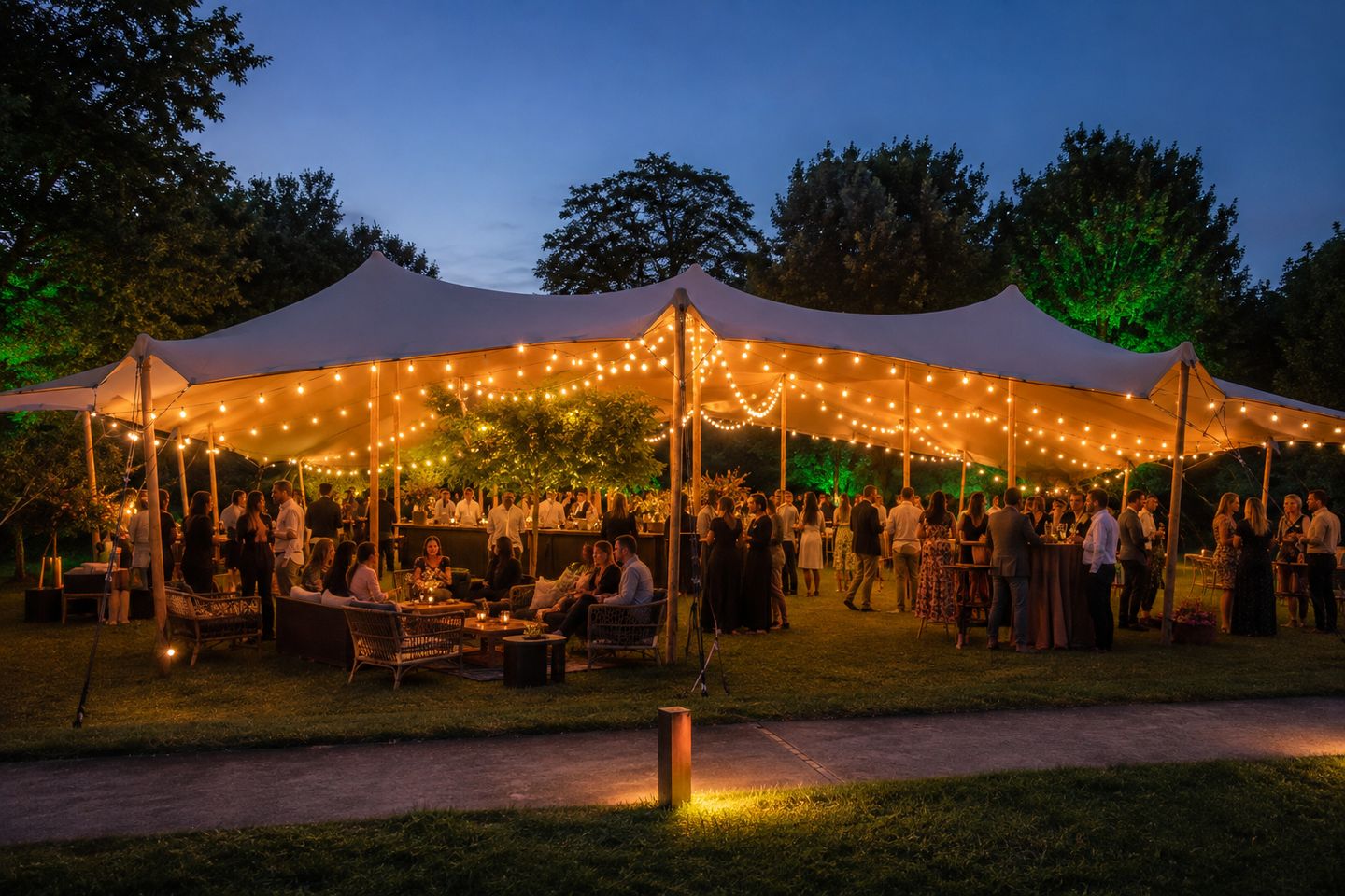 Night hospitality event beneath a Bedu tent illuminated with garlands
