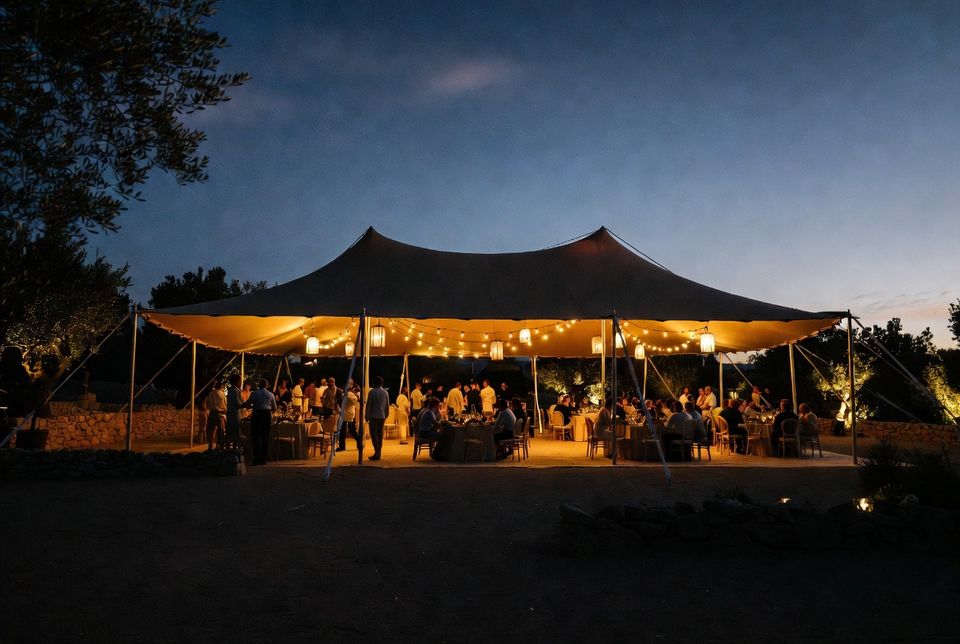 Night event beneath an illuminated Bedouin stretch tent