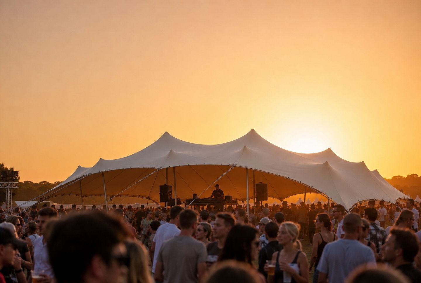 Festival at sunset beneath a large Bedu tent