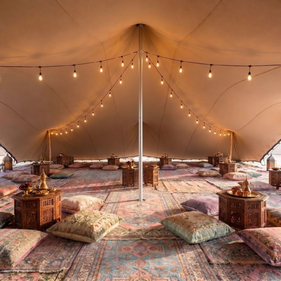 Event lounge beneath a stretch tent with warm lighting