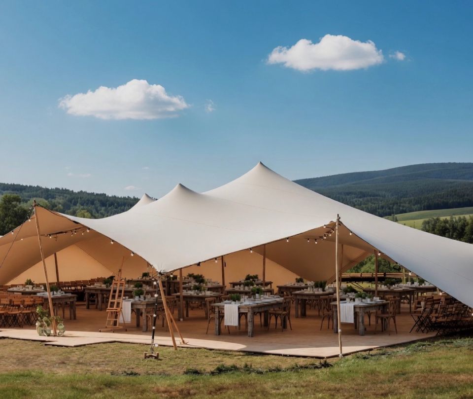 Wedding reception beneath a Bedouin tent with mountains beyond